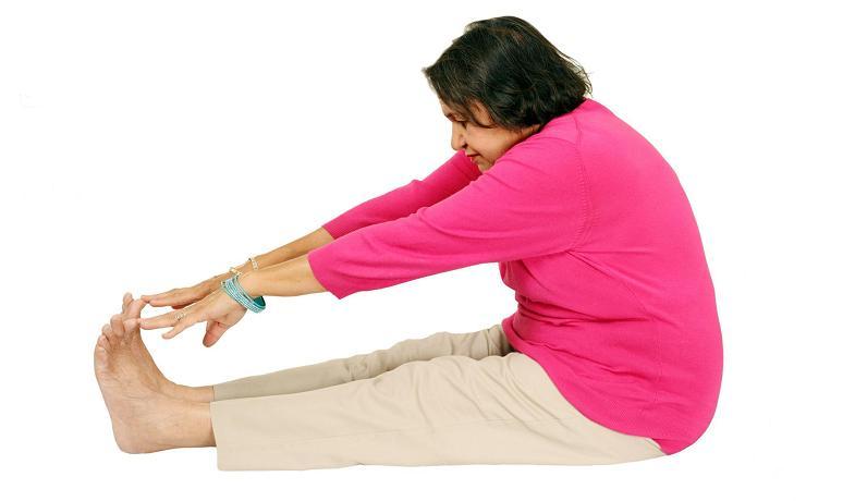 An elderly woman stretching 