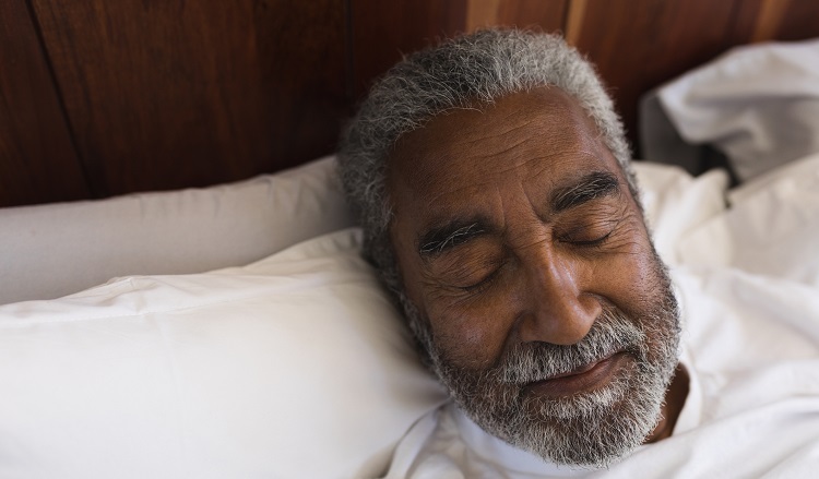 Close-up of a senior African American man sleeping peacefully in bedroom at home